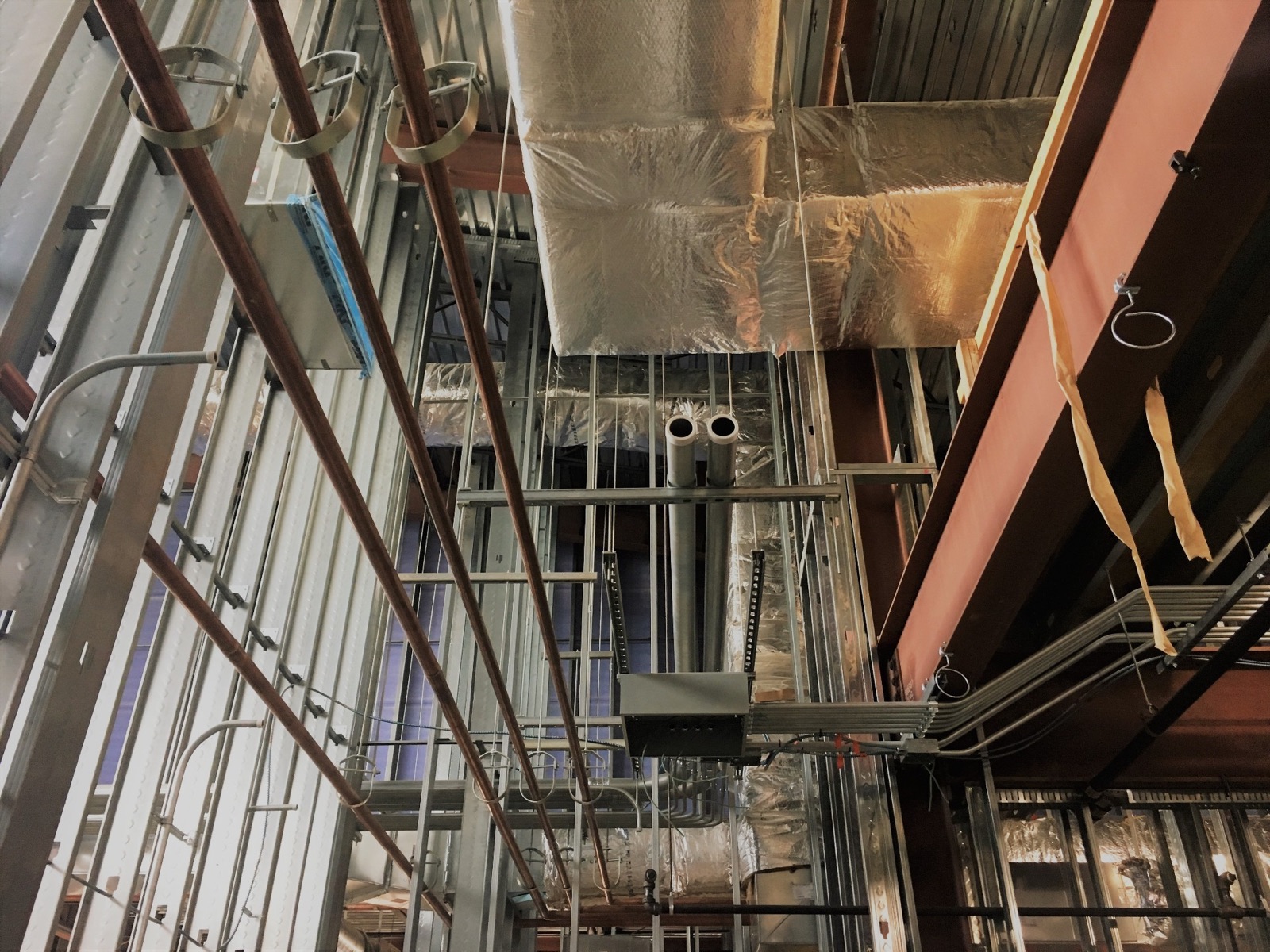 Overhead mechanical systems in a building under construction